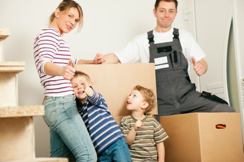 Boxes and furniture being carried through a flat corridor